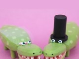 funny and cheerful crocodile toppers showing a bride and a groom are great for topping your wedding cake for some fun