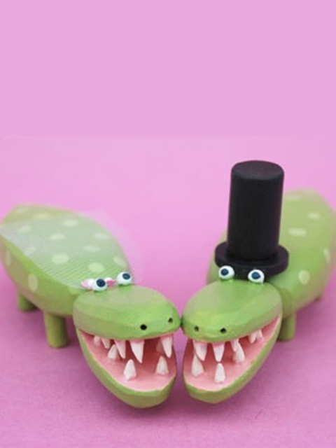 funny and cheerful crocodile toppers showing a bride and a groom are great for topping your wedding cake for some fun