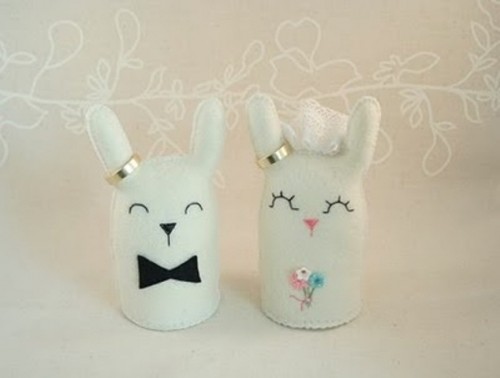 cute small porcelain bunny toppers with rings showing a bride and a groom are amazing to add a touch of cuteness to the cake