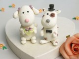 small and cool clay doggie cake toppers showing a bride with a bouquet and a groom in a bow tie and a top hat are very cute