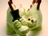 creative dinosaur cake toppers showing a bride and a groom kissing or biting are pure fun for a themed wedding