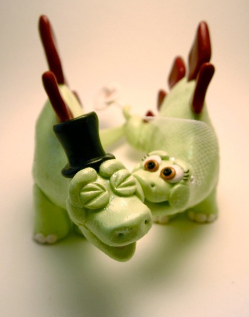 creative dinosaur cake toppers showing a bride and a groom kissing or biting are pure fun for a themed wedding