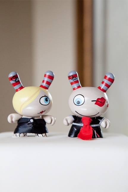 funny demon cake toppers showing off a girl and a boy in creative costumes are amazing for a wedding of a very daring and rock couple