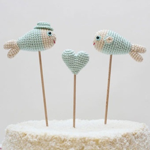 light blue and white crochet fish and a heart cake toppers are very lovely and cute ones for a themed wedding