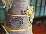 a bark wedding cake with neutrals, fake succulents, greenery and blooms for a woodland wedding