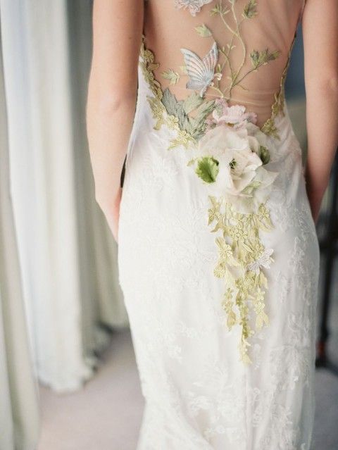 a chic lace sheath wedding dress with a sheer back with grene lace flower applique and leaves, a fabric flower and an embroidered birdie