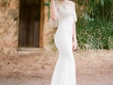 an elegant white mermaid wedding dress with spaghetti straps and an embellished coverup
