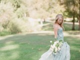a blue strapless wedding gown with a layered full skirt and a train will make your look gorgeously refined