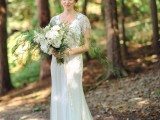 an art deco embellished wedding dress with a train and a V-neckline plus cap sleeves