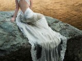 a silk sheath wedding dress with a train, an opeen back and criss-cross lace on the back plus a sheer veil with a lace edge