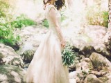 a neutral lace and tulle wedding dress with no sleeves and a high neckline plus an A-line skirt