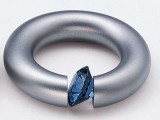 a metal ring with a blue crystal is a statement idea for a person who loves futurism a lot