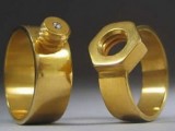 gold screw and nail engagement or wedding rings are a creative idea for an industrial or craft-loving couple