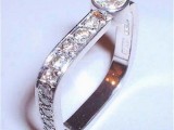 an unusual square engagement ring fully covered with diamonds and with an additional diamond on top for a glam engagement