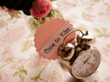 a clock with a funny tag is a cool decoration for a wedding table, pair it with blooms and greenery