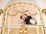 the couple kissing and holding a clock is a pretty and cool wedding portrait idea for a NYE wedding