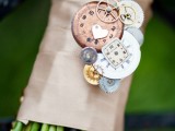 a tan wedding wrap with gears and little clocks attached to the wrap for a steampunk bride