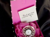 a black and pink box with a clock and a tag is a beautiful wedding favor, especially for a NYE wedding