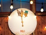a large clock with gold polka dots, silhouettes and monograms is a pretty wedding decoration for a NYE wedding