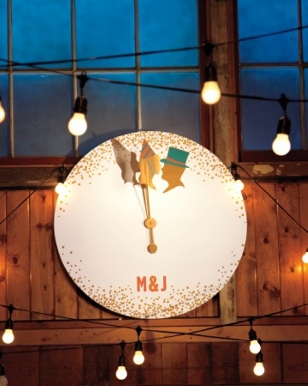 A large clock with gold polka dots, silhouettes and monograms is a pretty wedding decoration for a NYE wedding