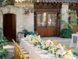 a neutral vineyard wedding reception with neutral linens, neutral and pink blooms and greenery is a chic and beautiful space