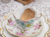 a refined floral teacup with a saucepan with a teabag escort card is a lovely idea for a brunch wedding