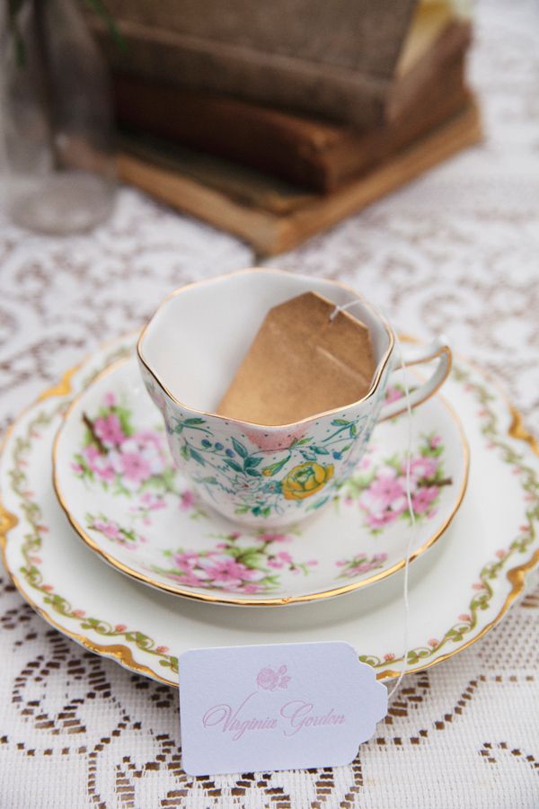 A refined floral teacup with a saucepan with a teabag escort card is a lovely idea for a brunch wedding