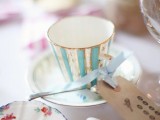 a blue striped vintage teacup with an escort card with blue ribbon is a great favor and holder idea