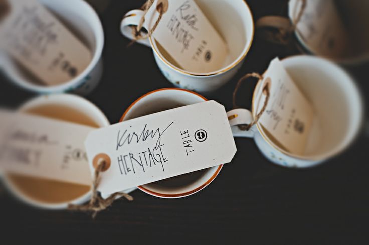 Vintage teacups on the table with tags are lovely favors and cool escort card holders