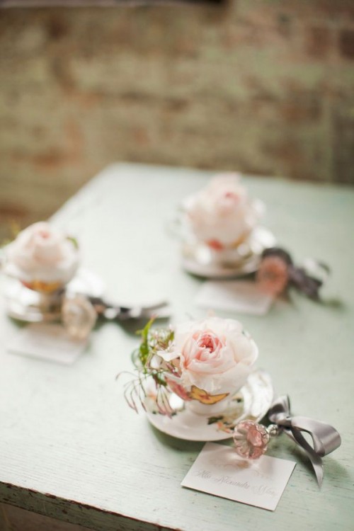 vintage teacuos with blush blooms and leaves and escort cards is a great idea for a vintage wedding