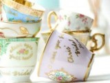 vintage teacups with gold touches are lovely wedding favors and escort card holders that won’t break the bank