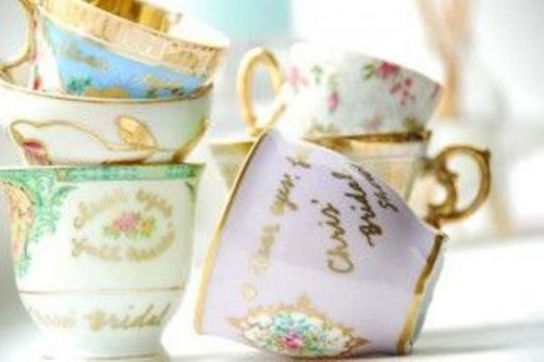 vintage teacups with gold touches are lovely wedding favors and escort card holders that won't break the bank