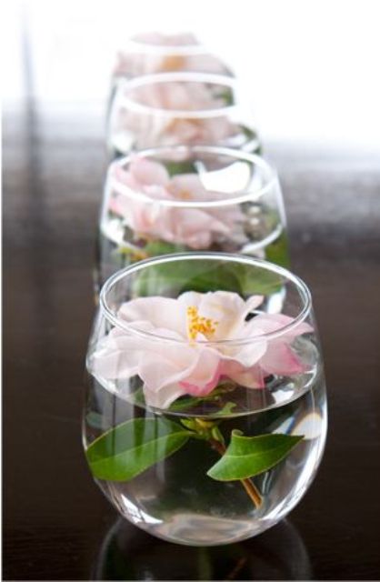 a clear jar with a single blush bloom floating in it will save your flower budget and will add a soft summer feel to the tablescape