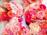 super bold summer wedding centerpeices of white jars with pink, blush, peachy blooms and berries are fun and bold