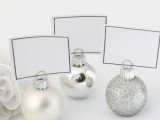 silver, glitter and mother-of-pearl ornaments to hold cards at the wedding tables