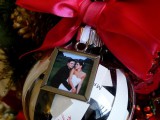 a pretty ornaments with your couple’s photo and a large red bow is a chic wedding guest favor idea