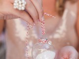 mini Christmas ornaments filled with faux snow and on ribbon are cute wedding favors that are budget-friendly