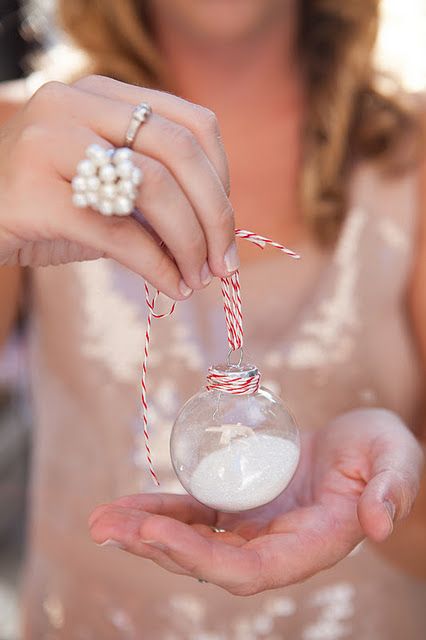 mini Christmas ornaments filled with faux snow and on ribbon are cute wedding favors that are budget-friendly