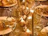 Christmas ornaments placed on the table runner and ornament-shaped candles are amazing to decorate your tables