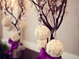 mini trees decorated with crystals and white snowy ornaments are amazing for yoru winter wedding venue decor