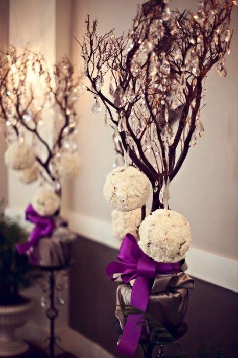 mini trees decorated with crystals and white snowy ornaments are amazing for yoru winter wedding venue decor