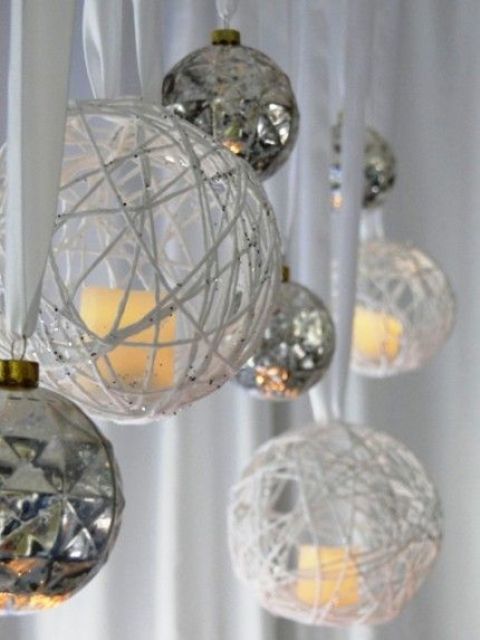 silver Christmas ornaments and yarn ornaments with candles can brign a holiday spirit to your ceremony and reception space