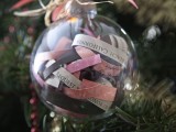 a sheer glass ornament filled with colorful paper with ribbon bows and paper elements is a nice decoration and favor
