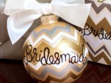give your bridesmaids cute personalized ornaments with large bows to make them happy