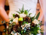 spruce up your wedding bouquet with pinecones and Christmas ornaments to make it ultimately holiday-like