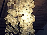 a chandelier made of white Christmas ornaments is a creative and fun idea with a strong holiday spirit
