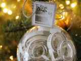 a sheer ornament filled with lines of your favorite song and with a stamp is a very cool idea for a holiday wedding