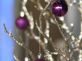 glitter and shiny purple ornaments on glitter branches are amazing for decorating your holiday wedding