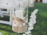 a jar with sand, pebbles, shells and a candle is great to line up the wedding aisle and make it cool