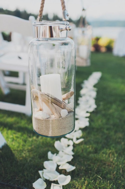 a jar with sand, pebbles, shells and a candle is great to line up the wedding aisle and make it cool